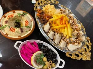 Chicken shawarma platter with hummus, fries, olives and pickles
