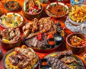 Halal Middle Eastern food platter with grilled meats, chicken, rice, hummus and traditional dishes